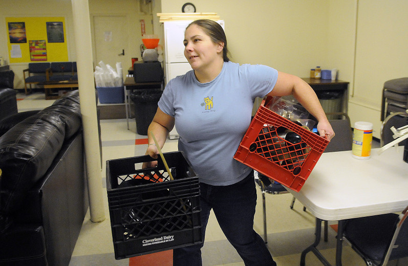 Augusta Community Warming Center Director Deidrah Stanchfield organizes items Monday at the new space at St. Mark’s Parish Hall at 9 Pleasant St. in Augusta.