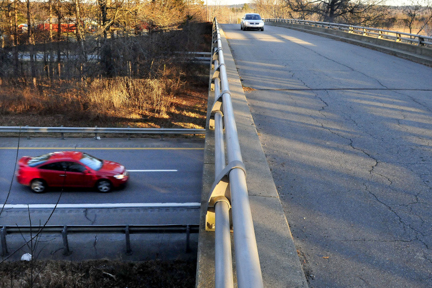 A vehicle travels west on the Trafton Road in Waterville as another passes under the overpass on Interstate 95 last month. A public meeting will be held on a proposed interchange at the site near the Sidney line.