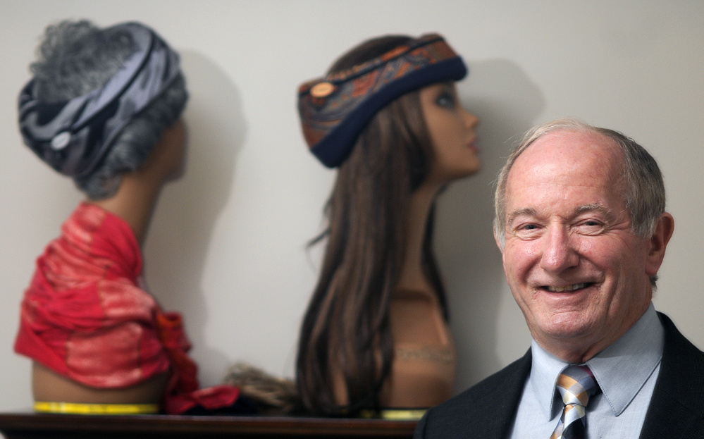 Alba Technic co-founder Jim Ferguson is next to a pair of mannequins adorned with Smarty head gear at the firm’s Winthrop office on Tuesday. The head injury prevention attire helped Alba Technic be selected as one of five companies across the country to receive $250,000 from the NFL, Under Armour and the federal government to pay to advance technology for safer sports equipment.