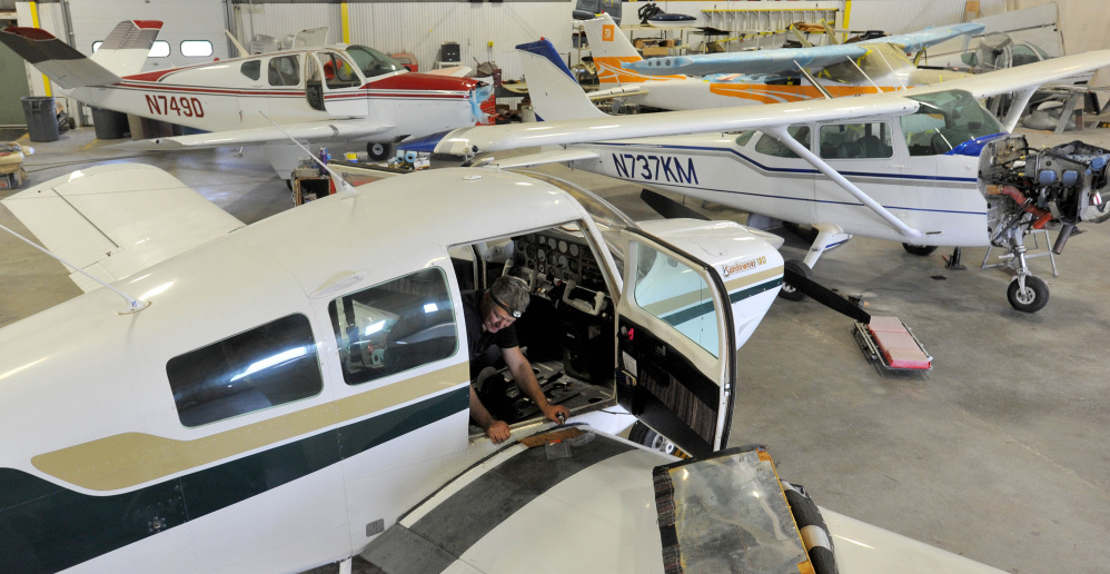 Ken Vautour, an aircraft mechanic with Black Bear Aviation, works on a BeechCraft on Oct. 2 at Robert LaFleur Municipal Airport, the municipally owned airport in Waterville. The City Council approved a five-year lease Tuesday to provide the growing company more space at the airport.