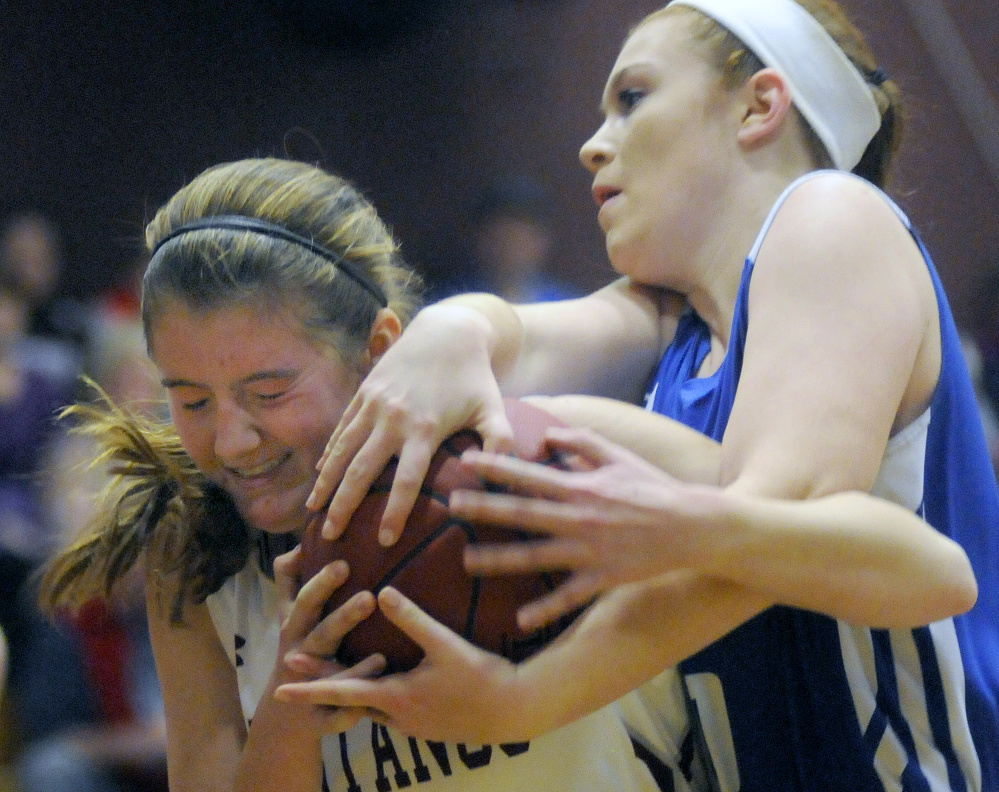 Monmouth’s Abbey Allen grapples with Madison’s Lauren Hay during a Mountain Valley Conference game Tuesday night in Monmouth.