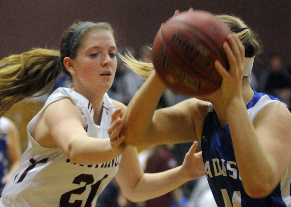 Monmouth’s Haley West blocks Madison’s Erin Whalen during a Mountain Valley Conference game Tuesday night in Monmouth.