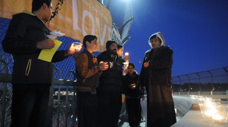 The Capital Area Multifaith Association and the Winthrop Area Ministerial Association organized this Lighting up Augusta With Hope and Love vigil Wednesday on Memorial Bridge in Augusta.