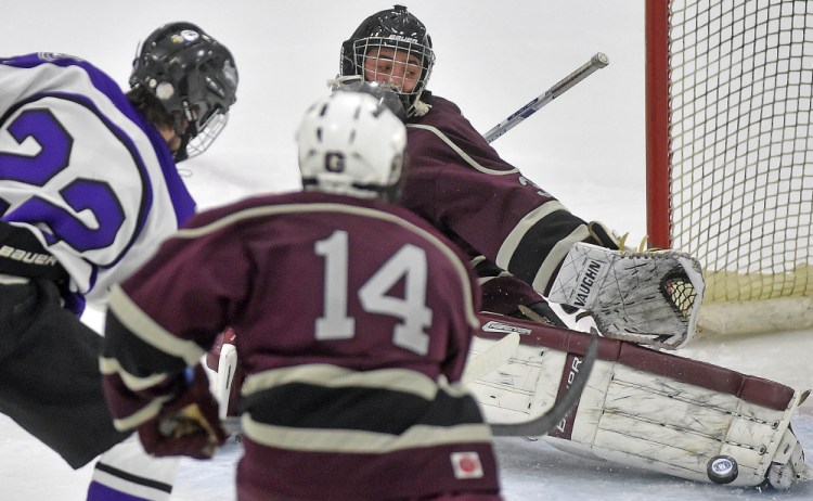 Greely High School goalie Joe McDonald (30) makes a toe save on a shot from Waterville Senior High School’s Cody Pellerin (22) in the second period at Colby College on Thursday.