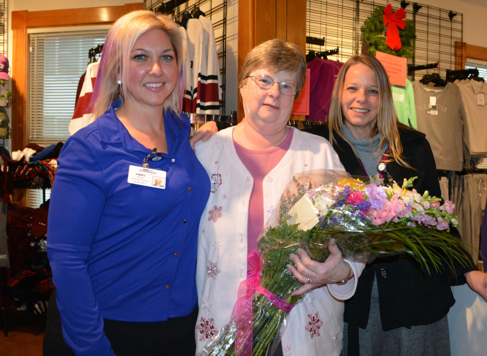 Lois King, center, receives her Hospice Volunteer of the Year award at the University of Maine at Farmington bookstore, where she works. King started a poetry program at Beacon Hospice in Augusta, among other volunteer efforts. Pictured with King are Aimee Brown, director of operations for the Beacon Hospice Augusta Care Center, left; and Kelly Herlihy, volunteer coordinator at Beacon Hospice in Augusta.