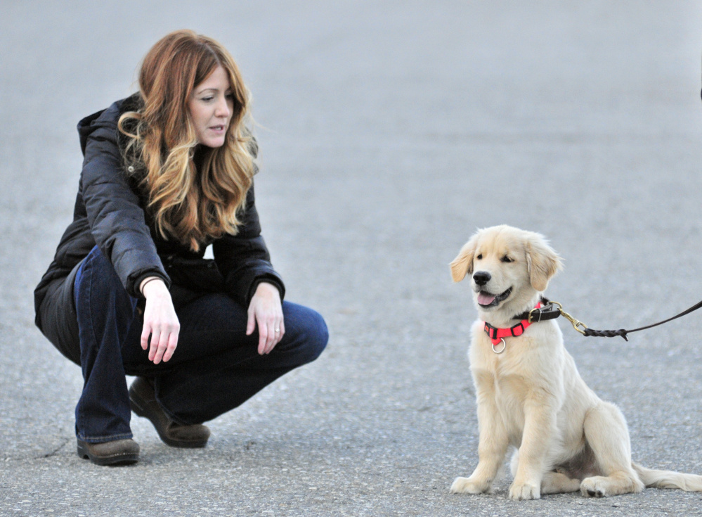 AmyLou Craig, left, and her puppy Brewer on Nov. 24 in a parking lot near the Kennebec River Rail Trail in Augusta.