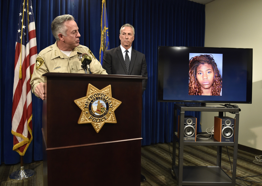 Clark County Sheriff Joe Lombardo, left, and Clark County District Attorney Steve Wolfson attend at a news conference in Las Vegas. The two officials spoke about the car driven by suspect Lakeisha N. Holloway, pictured on monitor, of Oregon, who was charged Tuesday with murder, child abuse and hit-and-run.
