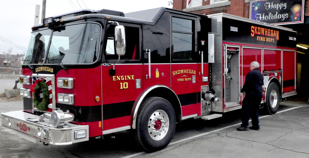 Skowhegan firefighter Linwood Corson examines the new rescue/pumper truck, Engine 10, at the department on Tuesday.