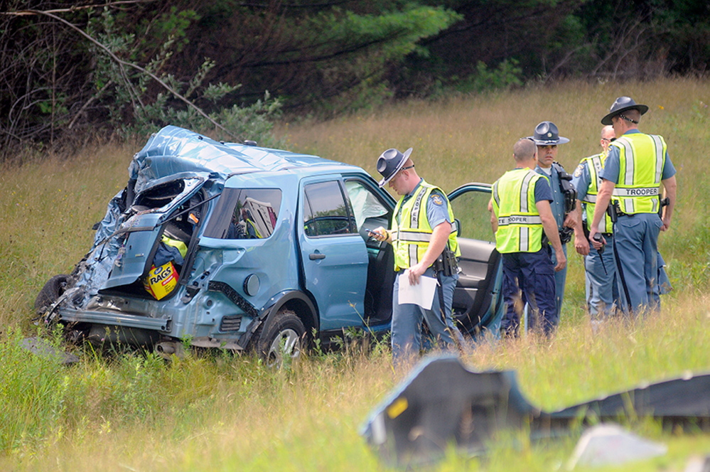 Maine State Police assess Trooper Greg Stevens’ cruiser in July after an accident on Interstate 295 in Richmond.