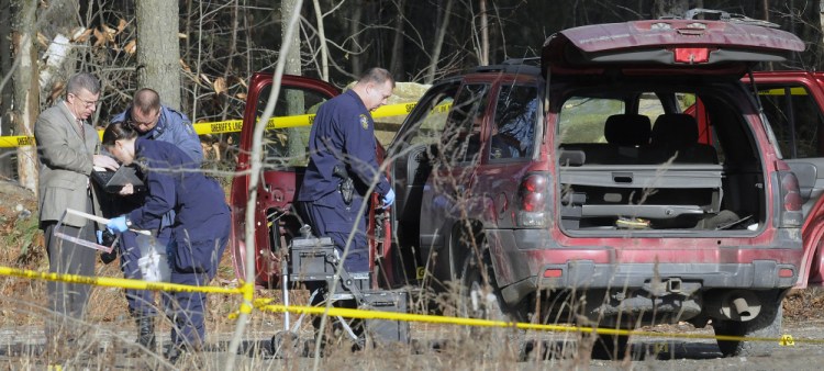 Staff photo by Andy Molloy
Maine State Police evidence technicians examine the SUV containing the bodies of Augusta residents Eric Williams, 35, and Bonnie Royer, 26, discovered Friday on Sanford Road in Manchester.