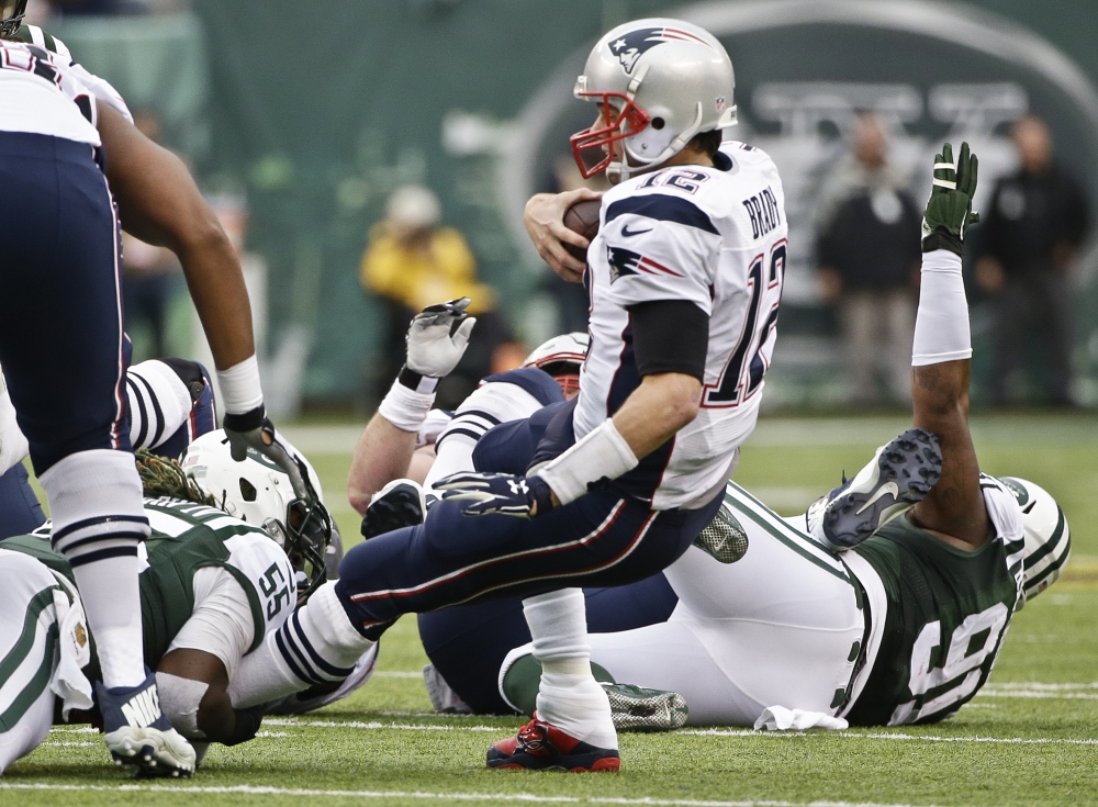 New York Jets outside linebacker Lorenzo Mauldin sacks New England Patriots quarterback Tom Brady in the third quarter Sunday at East Rutherford, New Jersey.