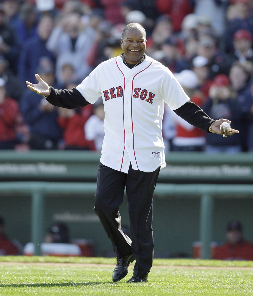 In this Oct. 11, 2009 photo former Boston Red Sox outfielder Dave Henderson walks onto the field to throw out the ceremonial first pitch before Game 3 of an American League baseball division series between the Boston Red Sox and Los Angeles Angels in Boston. Henderson, who hit one of the most famous home runs in postseason history, died Sunday after suffering a massive heart attack. He was 57.