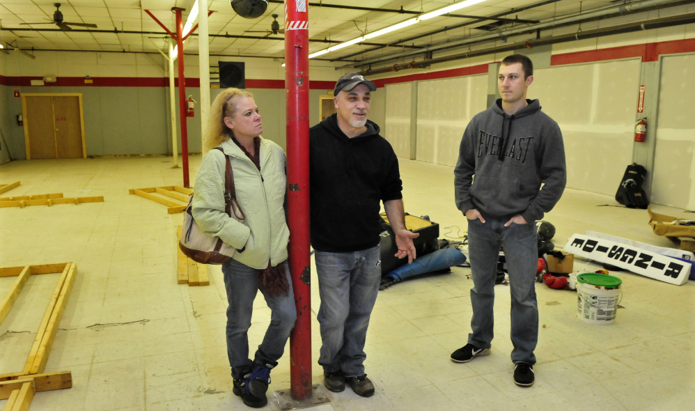 Staff photo by Dave Leaming
In this Dec. 14 photo. Mike Leary, center, speaks about his O’Leary’s Fitness boxing gym he is opening inside the former Marden’s store building on College Avenue in Waterville. Beside him is his partner Kathleen Jones and trainer Matt Field.