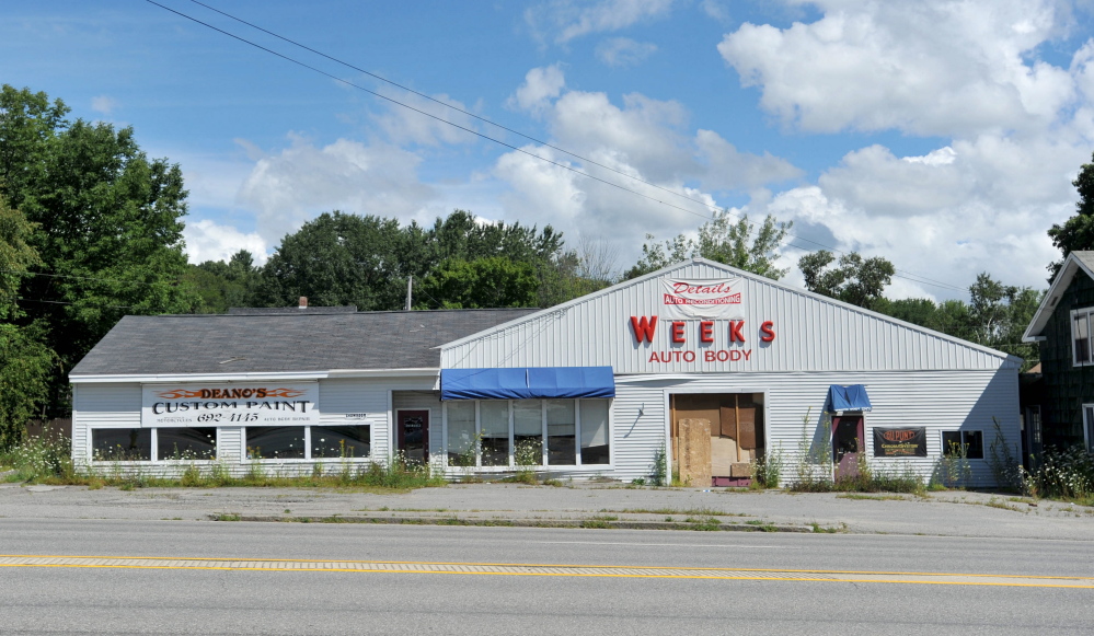 The former Weeks Auto Body building on Kennedy Memorial Drive in Waterville was torn down last week, including the former Weeks house, seen partially at right. Property owner Jerald Hurdle said he doesn’t yet know what he’ll do with the property, where he had planned a car and dog wash before his request to rezone was shot down in August.