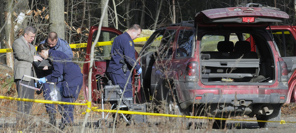 Maine State Police evidence technicians examine the SUV containing two bodies discovered Friday on Sanford Road in Manchester. Bonnie Royer and Eric Williams died of gunshot wounds, police said.