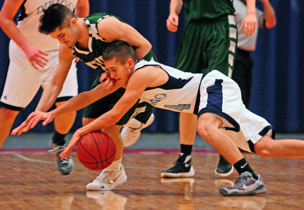 Winthrop’s Nate Scott, top, and Dirigo’s Luke Lueders battle for a loose ball during the Capital City Hoops Classic on Wednesday at the Augusta Civic Center.