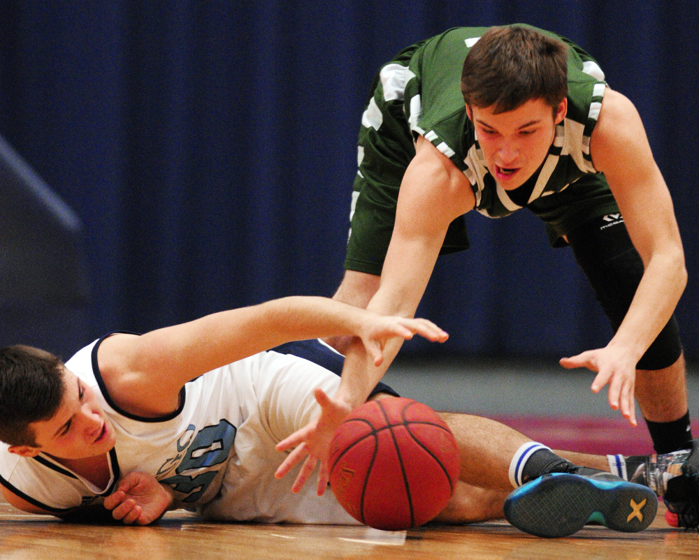 Winthrop’s Bennett Brooks, top, and Dirigo’s Alex Gorham battle for a loose ball during the Capital City Hoops Classic on Wednesday at the Augusta Civic Center.