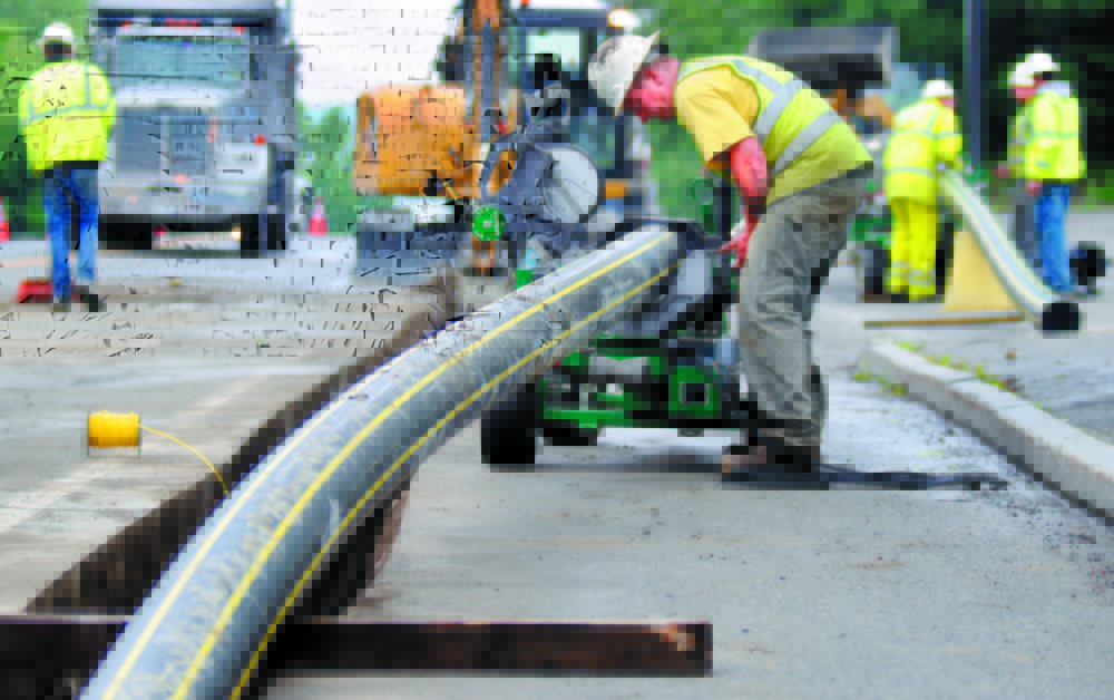 Workers with Bowdoin Excavation lay gas pipes in Augusta for Maine Natural Gas in this 2013 file photo.