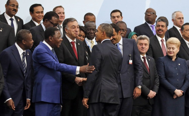 President Obama is greeted by the president of Benin, Thomas Boni Yayi, as Obama arrives for a photo with other world leaders at the climate change conference outside Paris. “No nation large or small, wealthy or poor, is immune” from the threat, Obama said.