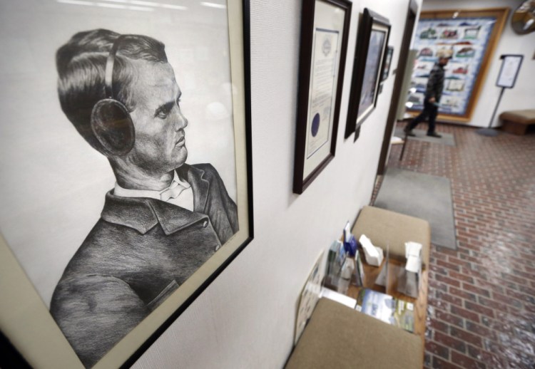 A portrait of earmuffs inventor Chester Greenwood hangs at the municipal offices in his hometown of Farmington. In 1873 at age 15, Greenwood made his first pair of “ear protectors” with help from his grandmother after he returned from a cold day of ice skating.