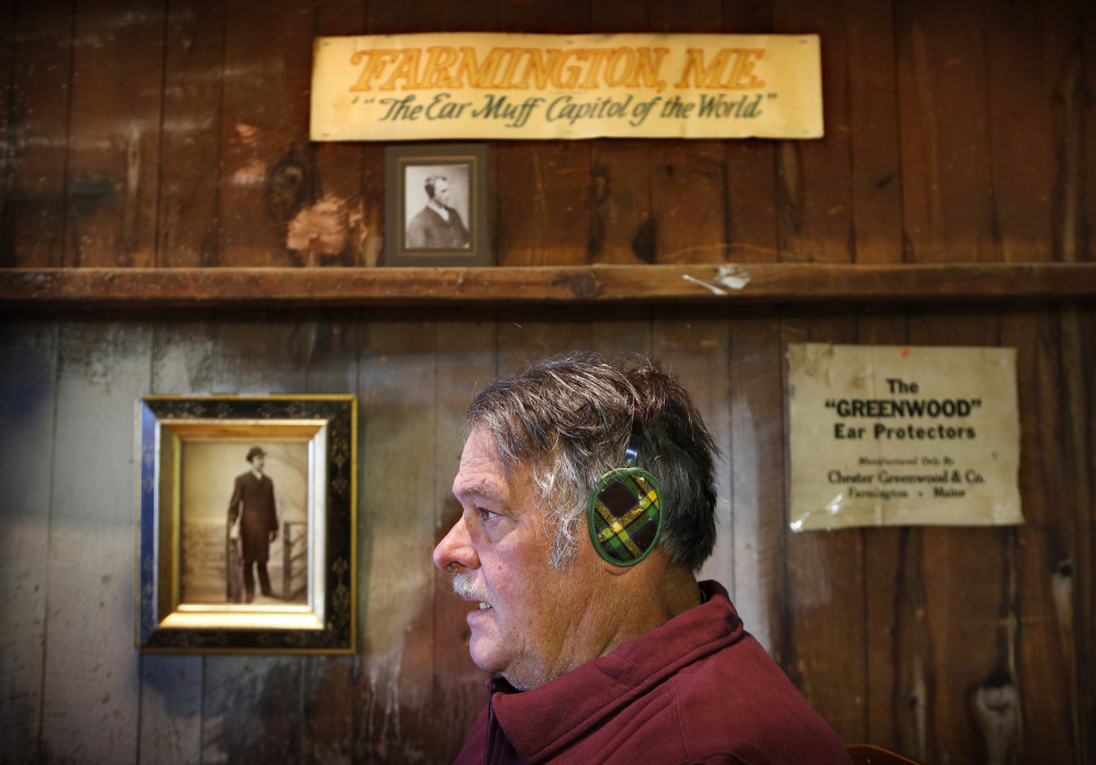 Ronald Greenwood, 75, a great-grandson of Chester Greenwood, models a pair of original “Champion Ear Protectors” in his barn in Farmington.