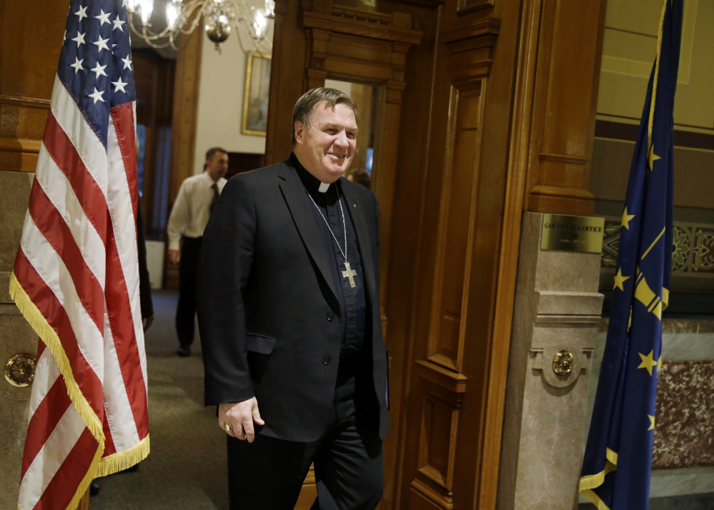 Indianapolis Archbishop Joseph Tobin leaves the governor’s office after a meeting with Indiana Gov. Mike Pence at the Statehouse, Wednesday, Dec. 2, 2015, in Indianapolis, the day after the archdiocese said it has the means to resettle a Syrian refugee family bound for the state.
