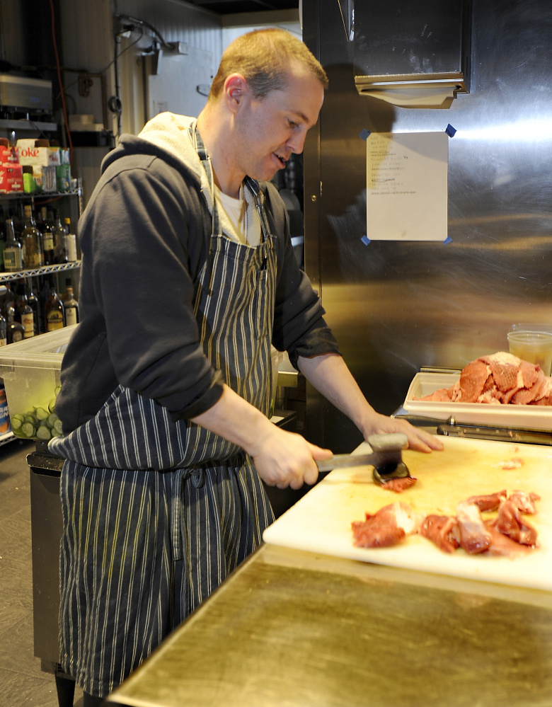 Ben Groppe prepares pork for Katsu wearing one of Desjarlais’ aprons.