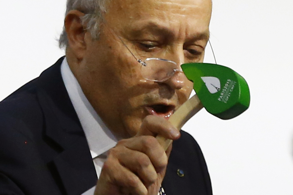 French Foreign Minister Laurent Fabius finally put the hammer down Saturday to seal a global agreement asking all countries to reduce or rein in greenhouse gas emissions. The Associated Press