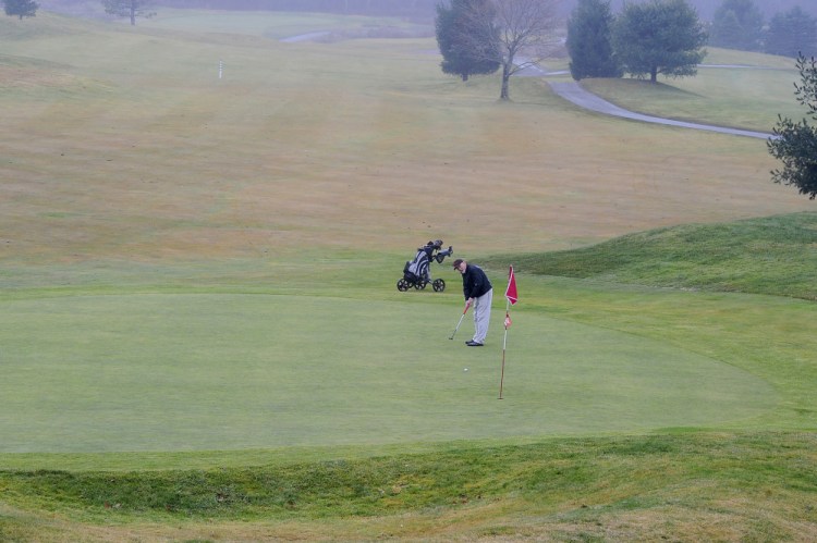 Jim Reilly putts on the ninth green at Nonesuch River Golf Course on Monday. Reilly played 18 holes at Nonesuch on Saturday, when the high temperature was 57 degrees. “I call it bonus golf,” he said.