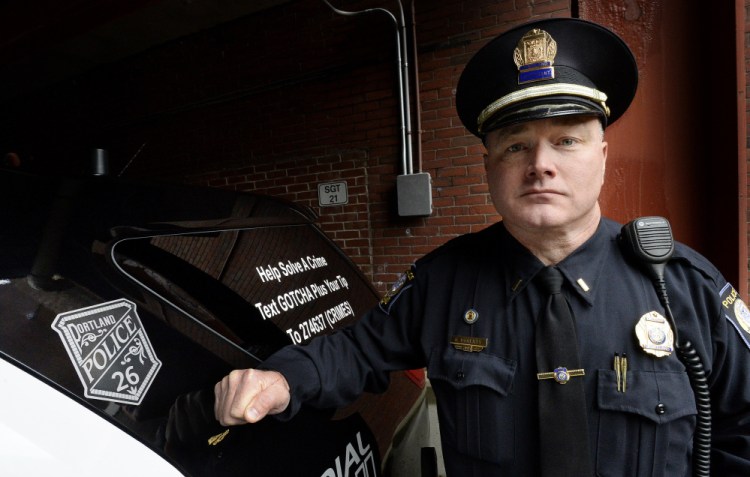 Portland police Lt. Robert Doherty shows the cruiser decal – Badge No. 26 – that memorializes Officer Charles McIntosh, the first in Portland to be killed in the line of duty. “It’s a reminder that your service ... will not be forgotten,” Doherty said.
