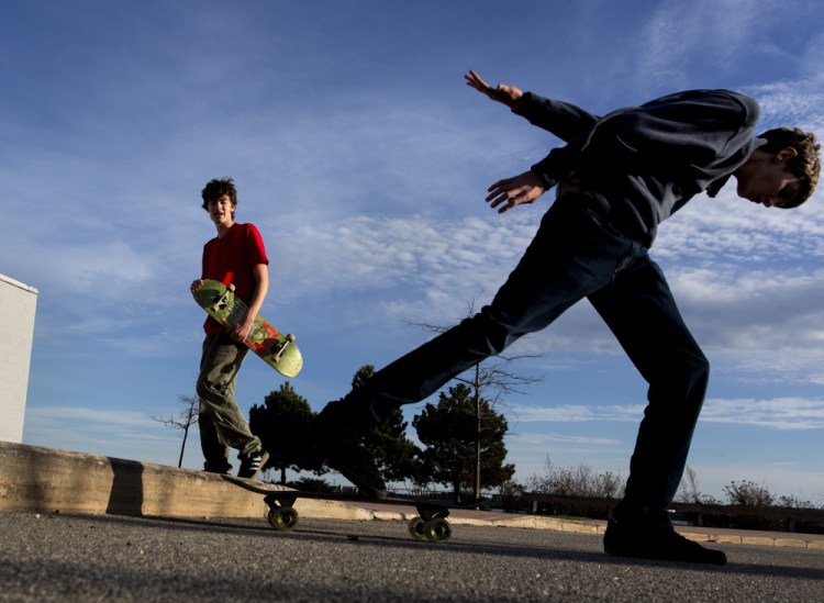 Aidan Parker looks on as his brother Julian Parker skates at Portland's Ocean Gateway Terminal on Christmas Day, the warmest Christmas on record in Portland.
Gabe Souza/Staff Photographer