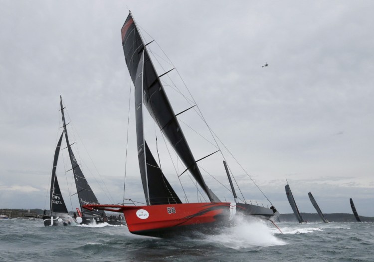 Comanche, center, shown in Sydney Harbor during the 71st Sydney to Hobart Yacht race in 2015, has broken a trans-Atlantic crossing record.