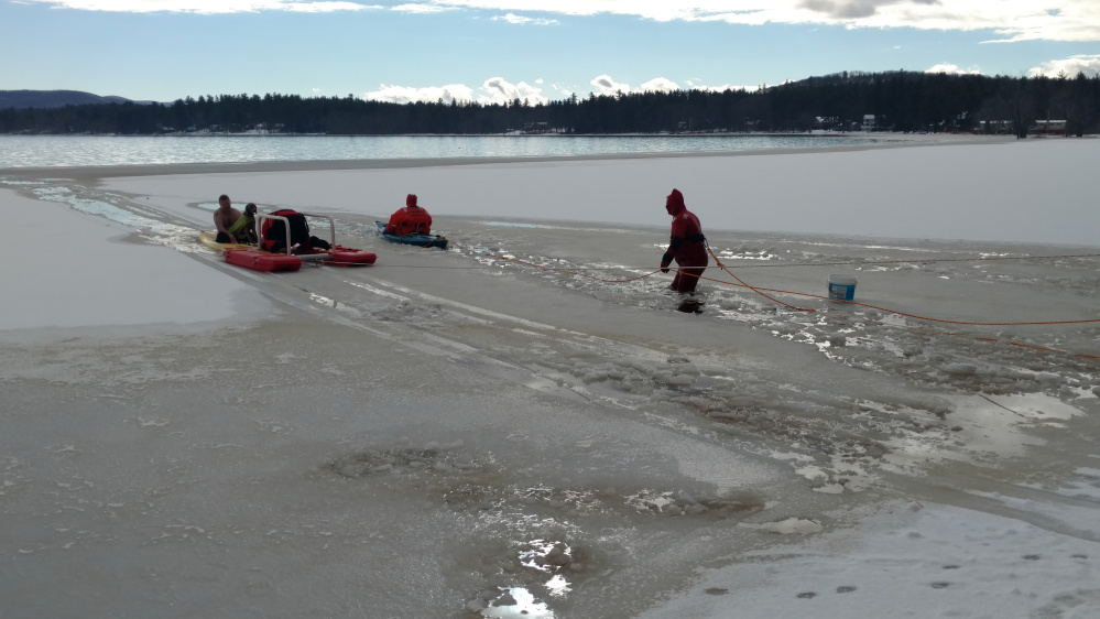 Fryeburg firefighters venture into Lovewell Pond to rescue a dog and a man on Thursday.