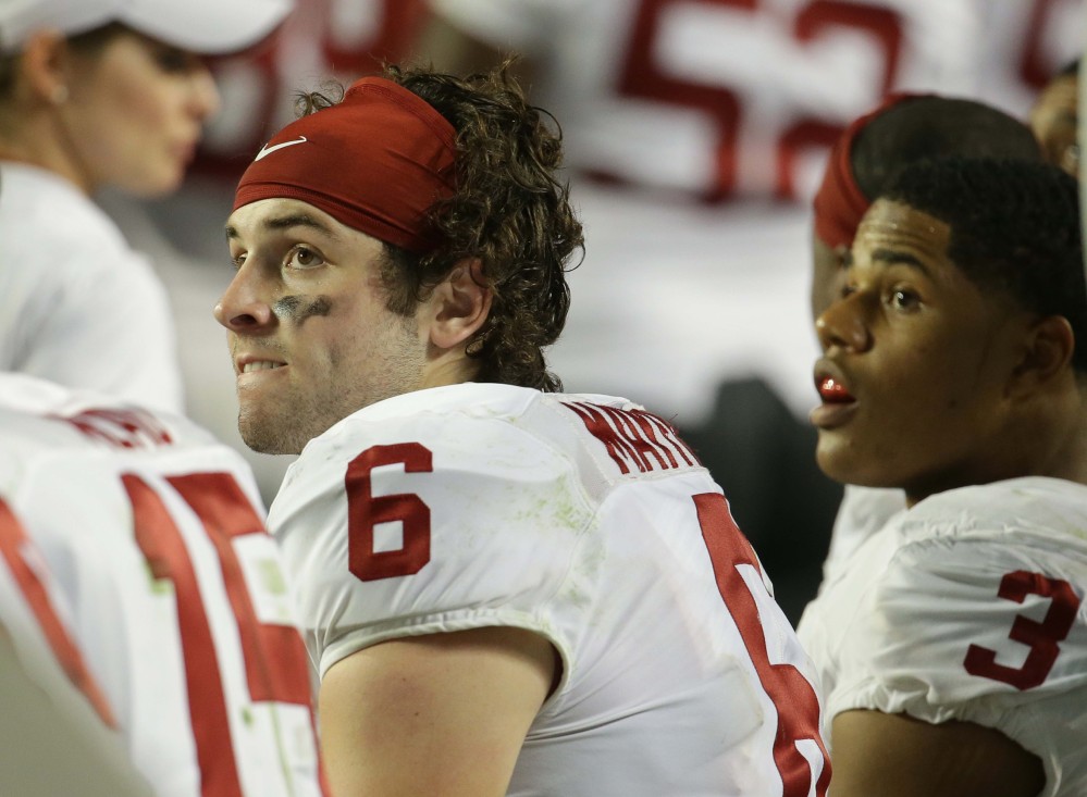 Oklahoma quarterback Baker Mayfield (6) and wide receiver Sterling Shepard (3) look up at the scoreboard, which was in Clemson’s favor during the second half of the Orange Bowl.