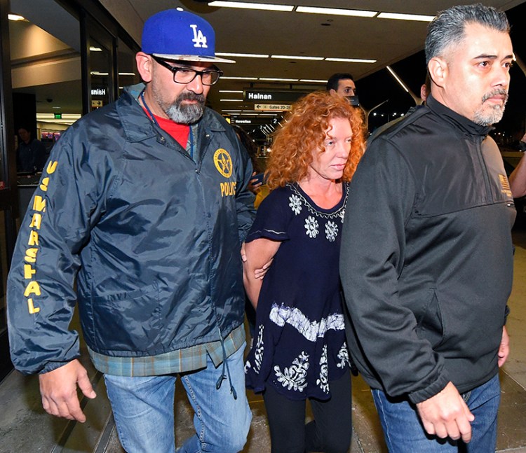 Tonya Couch, center, is taken by authorities to a waiting car after arriving at Los Angeles International Airport from Mexico on Thursday.