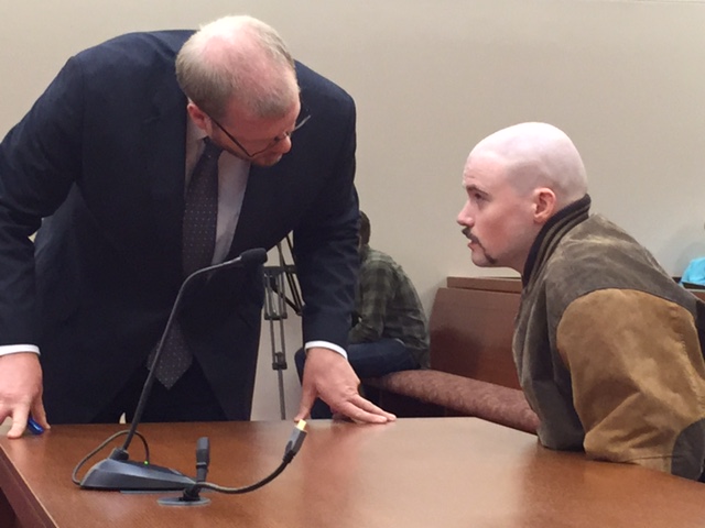 Attorney Scott Hess talks with his client Leroy Smith III Wednesday during a hearing in which the state wants permission to involuntarily medicate Smith so he can be made competent to stand trial in the death of his father.