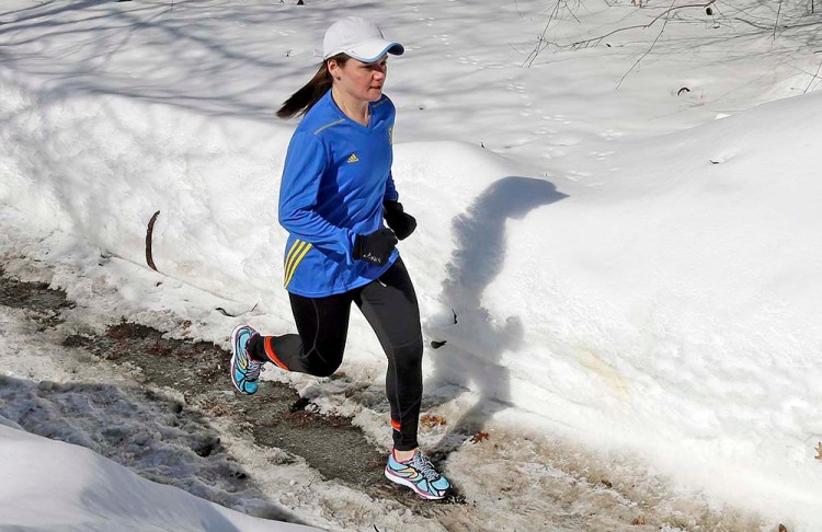 Becca Pizzi trains for the Boston Marathon along Heartbreak Hill in Newton, Mass., in this In this Feb. 27, 2015 photo. Pizzi, a veteran of 45 marathons, vies to be the first American woman to complete the World Marathon Challenge. The Associated Press