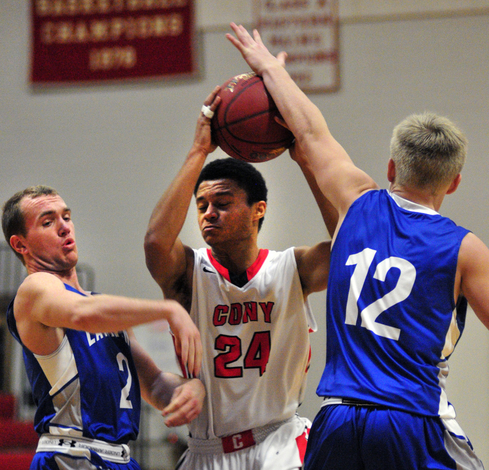 Cony’s Jordan Roddy (24) goes for shot while being defended by Lawrence’s J.T. Nutting, left, and Brandon Hill (12) during a game Saturday at Cony High in Augusta.