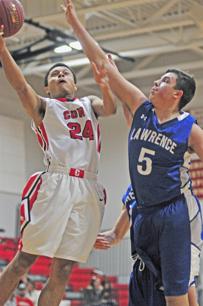 Cony’s Jordan Roddy, left, shoots against Lawrence’s Braden Bell during a game Saturday at Cony High in Augusta.