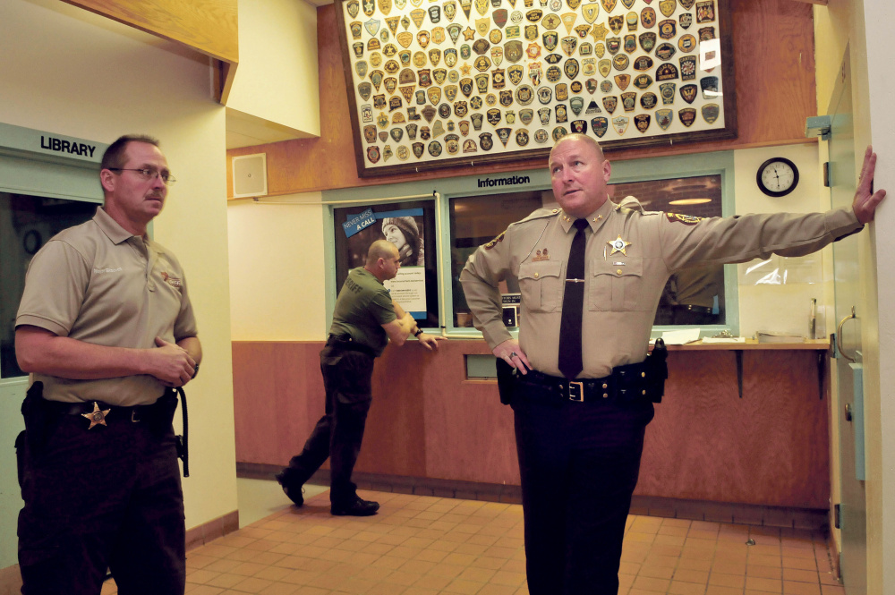 Franklin County Jail Administrator Major Douglas Blauvelt, left, and Sheriff Scott Nichols speak inside the entry lobby and control room to the jail in Farmington in October. Nichols said reopening the jail was a big success in 2015, and he looks forward to more in 2016.