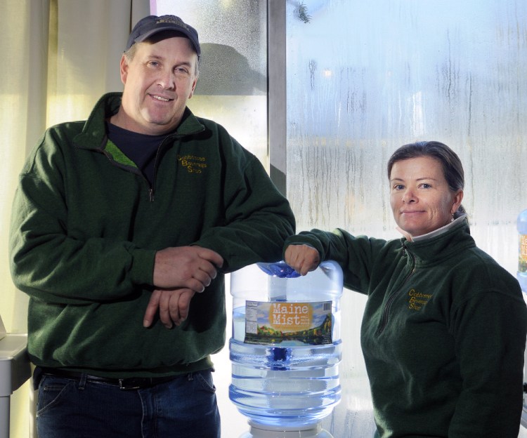 Ed and Deb Bowie, shown in a photo taken last week, are bottling and selling a line of water, Maine Mist, at their Farmingdale business, the Cobbossee Beverage Shop.