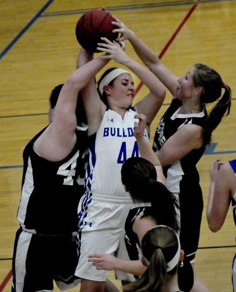 Madison’s Erin Whalen is boxed in by a swarming Carrabec defense during a Mountain Valley Conference game Monday night in Madison.