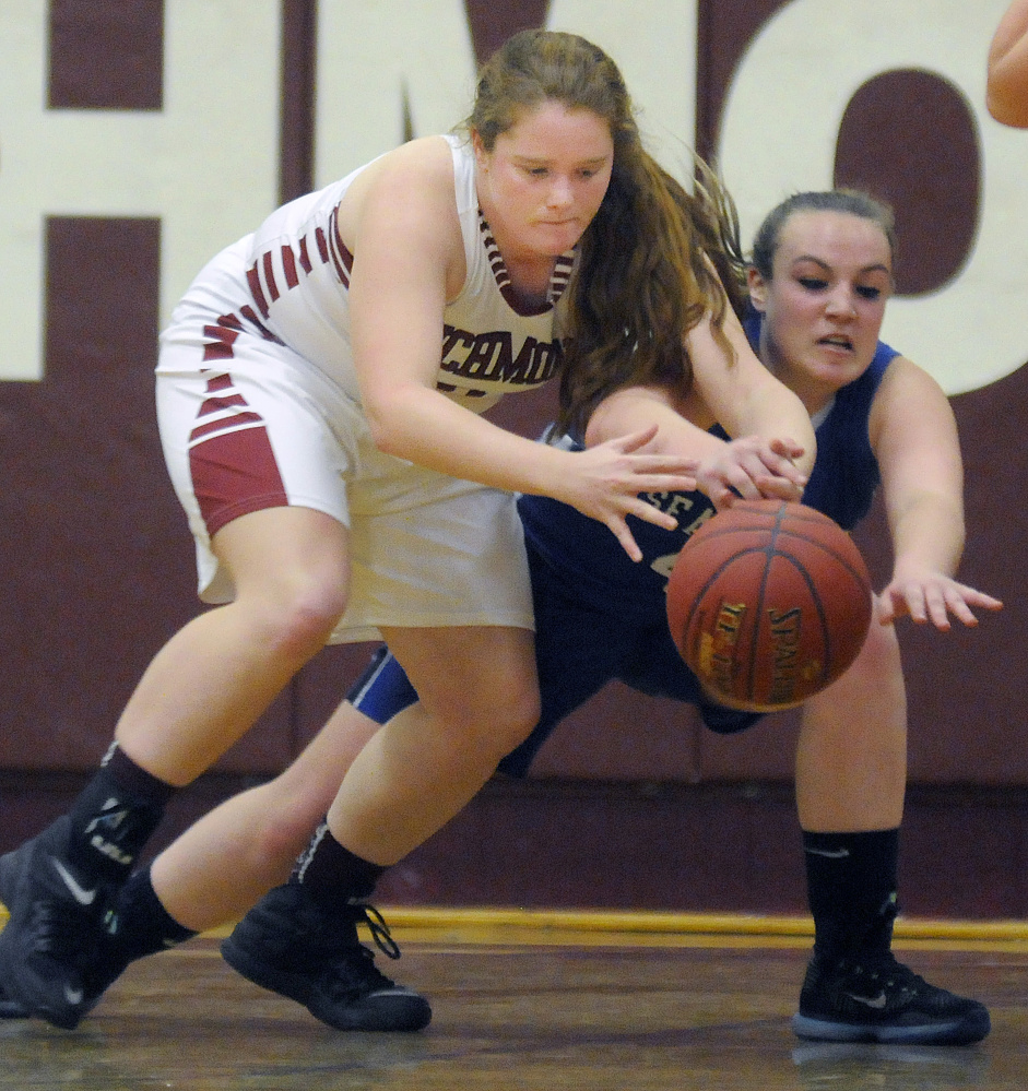 Richmond’s Kalah Patterson, left, reaches for a loose ball along with Searsport’s Anna Bucklin during a Class C South game Monday night in Richmond.