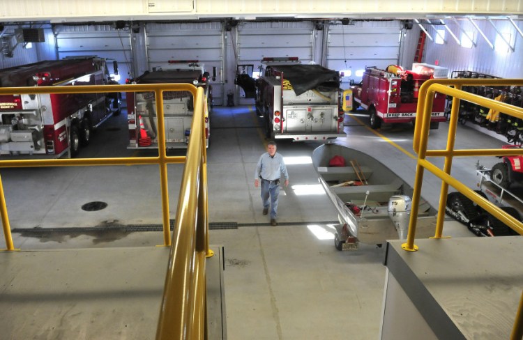 Norridgewock Fire Chief Dave Jones walks through the large equipment bay inside the new fire department building on Tuesday. The department moved from the old building after a 30-year money-raising campaign.