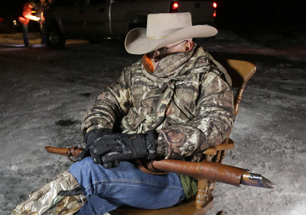 Arizona rancher LaVoy Finicum, holds as he guards the Malheur National Wildlife Refuge, Tuesday near Burns, Ore.