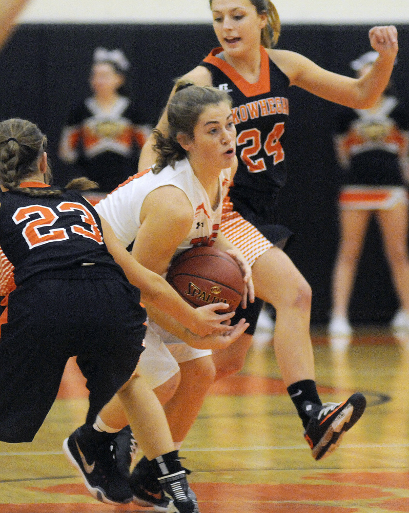 Gardiner’s Lauren Chadwick, center, dribbles through Skowhegan’s Alyssa Everett, left, and Tracey Swanson during a Class A North game Dec. 23. Swanson helps lead a young Indians team that has playoff aspirations.
