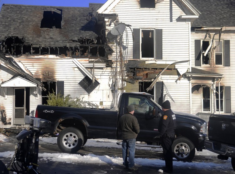 Gardiner Fire Chief Al Nelson, right, and Lt. Josh Johnson assess on Thursday the home that burned Wednesday on Riverview Drive in Gardiner.