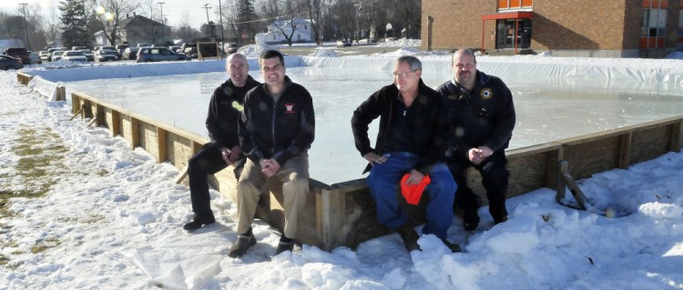 The outdoor public ice skating rink beside the Winslow Middle School is ready to open Saturday. From left are Winslow firefighter Tom Brown, Jim Bourgoin, director of Winslow Parks and Recreation, Ray Caron and firefighter Eric Rood.