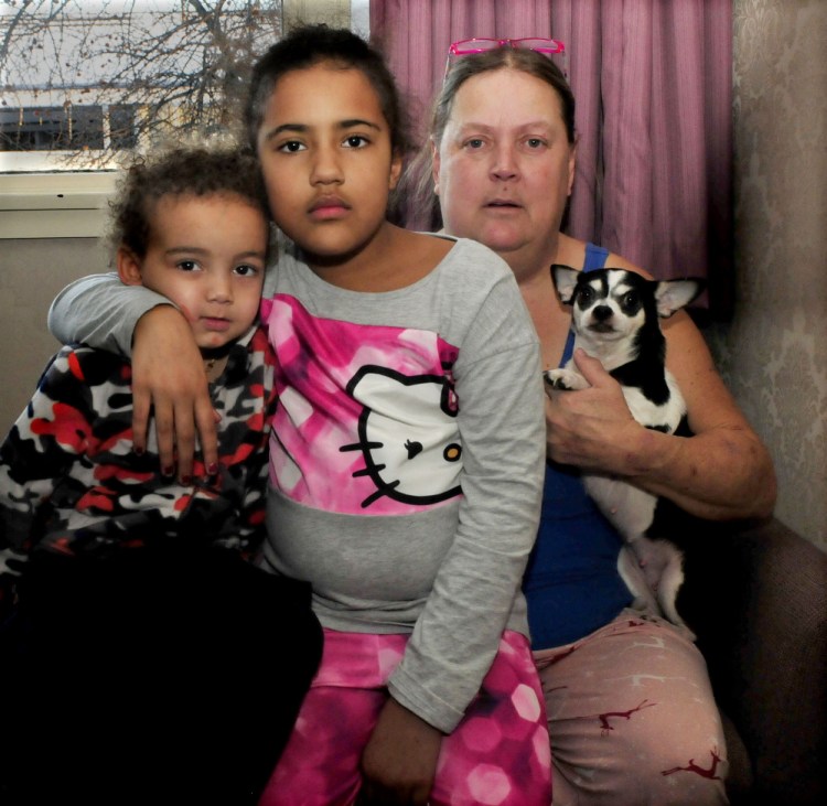 Jody Brunson holds her grandchildren, Booker, left, and Jocelin, and one of four pets saved from a Jan. 3-4 fire that destroyed the home they were living in at 144 Water St. in Waterville. The family, which also includes Brunson’s daughter Marybeth, is moving back to South Carolina.