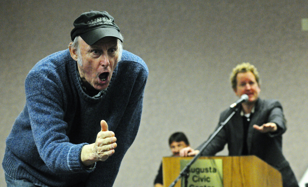 Rosey Gerry, left, encourages an audience member to make a bid Saturday while Ethan Yankura serves as auctioneer Saturday at the Augusta Civic Center. The event was a fundraiser for the Maine Vintage Race Car Association.